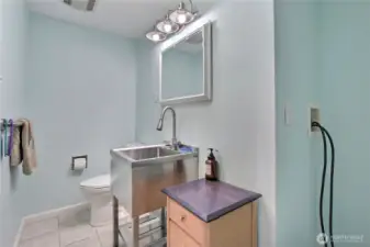 Powder room off of dining room, plumbed for stackable washer/dryer.