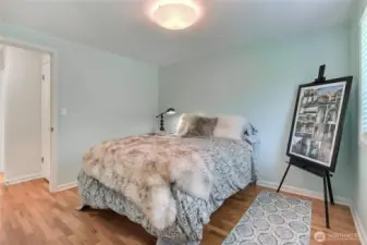Bedroom 1, updated lighting and beautiful floors.