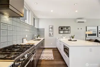 Sleek backsplash, microwave, quartz countertops. This is how it should be.