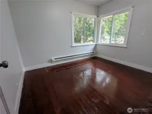 Primary bedroom also with hardwood floors