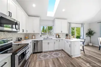 Stunning remodeled kitchen w/ shaker cabinetry & durable quartz countertops.
