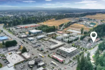 Larger spread out drone shot of surroundings.  Lots of shopping, restaurants and amenities.