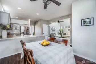 This inviting breakfast nook flows seamlessly into the eat-in kitchen, featuring a spacious bar with additional seating—perfect for casual meals, entertaining, or morning coffee with a view of the living area.