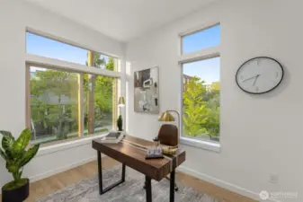 Surrounded by natural light and treetop views, this flex room is the perfect WFH setup or reading retreat.