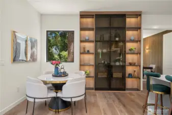 The cozy breakfast nook offers direct access to a charming private deck, perfect for morning coffee or casual meals.