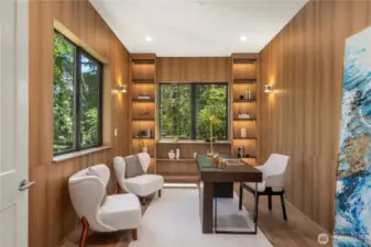 The dedicated home office features a custom built-in shelf with integrated lighting, offering both functionality and sophistication—perfect for focused work or creative pursuits.
