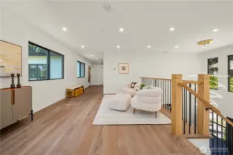 A thoughtfully designed landing with a built-in sitting area offers a peaceful nook upstairs—ideal for morning coffee, study, or reflection.