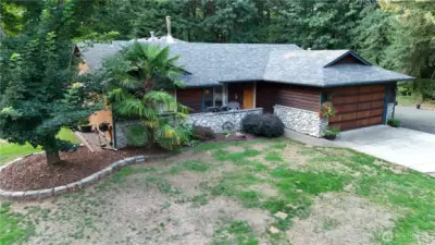 Front of home with log and river rock accents.