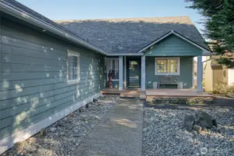 New Roof. Garage window trim has been painted white. No yard maintenance here! To the right of the picture is a small cluster of trees where the deer like to hang out.