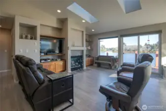 Lots of built-ins in the main livingroom. Above the fireplace is an artistic design in the plaster of mountains.