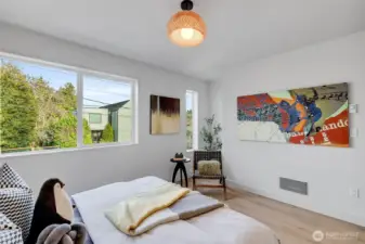 The articulation of diverse window geometries enhances spatial character, channeling abundant light while maintaining controlled privacy.