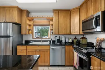 Modern Beadboard-Style REAL Oak Cabinets, SS Whirlpool Appliances, a convenient Hall Pantry & a Garden Window overlooking the Back Yard!