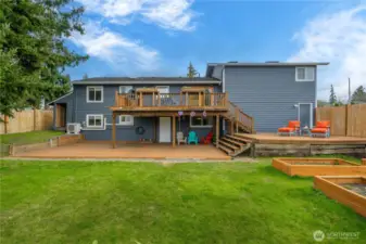 Rear view of yard and decks