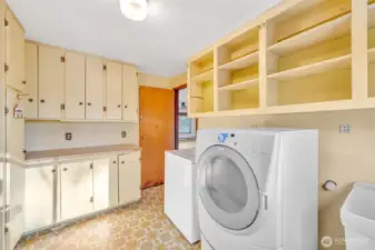 Laundry room on same floor as the kitchen has lots of storage