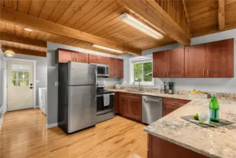 Sleek stainless appliances and beautiful stone countertops make a rustic cabin feel modern.