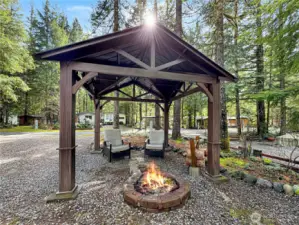 Gorgeous open sided gazebo tht covers the fire pit.