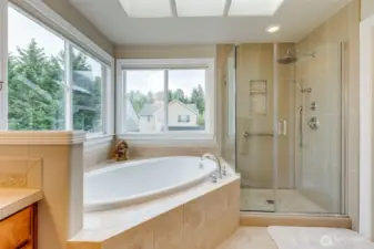 Tile work in primary, 5 pc bath, soaking tub, skylights, natural light.