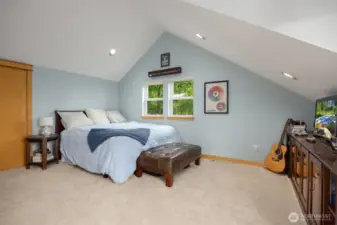 This bedroom enjoys vaulted ceilings and Puget Sound views.