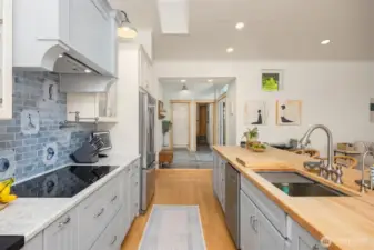 The newly remodeled kitchen is truly the heart of this home with new hand crafted tiles, easy pull out drawer storage, and wood car-decking vaulted ceiling.