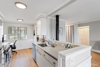 The open kitchen plan facilitates interaction and conversational flow. Notice the modern upgrades: Quartz counters, light fixtures and instant hot water dispenser!