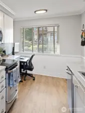 This area off the kitchen can be used for casual dining or additional office space. The large South-facing window fills the room with light and provides outdoor vistas.
