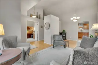 Main floor living room offers ample natural light and leads into the dining and kitchen areas.