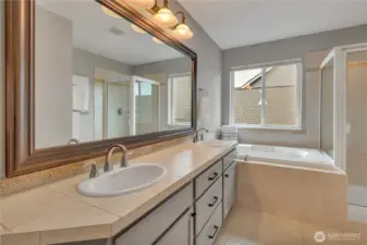 Tiled floors, large double vanity, lots of storage, soaker tub, walk-in closet, & a separate toilet area = the perfect primary bath.