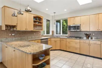 Expansive kitchen has upgraded polished look. Efficient space to cook. Plenty of storage and countertop space. New gas cooktop and dishwasher. Copper sink.