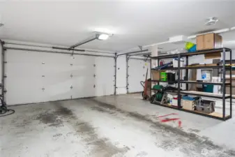 Very large garage with a double garage door and a single garage door.