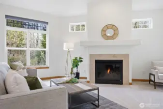 Looking toward the fireplace with the window looking out to the stream and nature beyond.