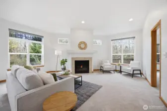 Another view of the spacious living room with nature surrounding this unit.