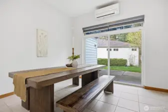 The dining room opens out to the large concrete patio that takes in nature along the stream.