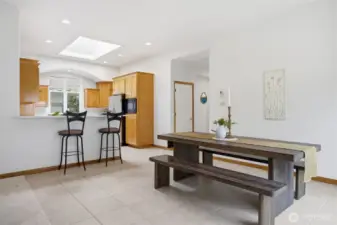 The floor plan is open and the sunlight streams in through the windows and skylights.