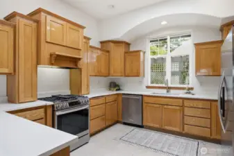 The 5-burner gas range has a concealed vent hood.