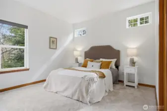 The primary suite is just off the living room and looks toward the stream, which gives it great privacy.