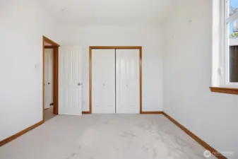 Looking across the 2nd bedroom toward the full bath.