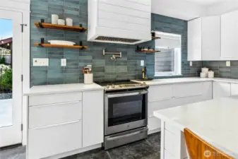 The thoughtfully designed kitchen has quartz countertops, a Samsung Bespoke Collection Refrigerator, Kohler Sink and Faucet, Bosch Dishwasher, GE Range & Hood, a Kohler pot-filler, plus a large pantry.