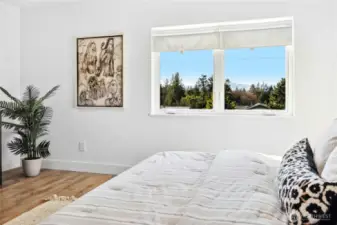 This bedroom has sweet Olympic Mountain and water views.