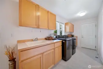 Laundry room with plenty of counter top/cupboards.