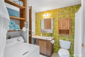 Convenient in-home laundry setup with built-in storage—just what you need for sandy beach towels and weekend escapes.