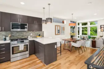 Open concept living/dining/kitchen w/ gas fireplace & floor to ceiling windows