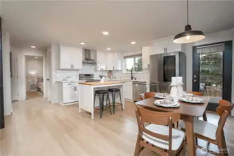 Open kitchen-dining space with modern finishes, cozy lighting, and natural wood tones.