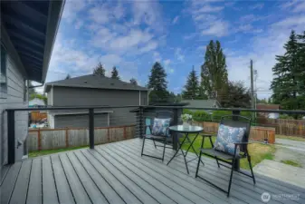 Spacious outdoor deck with seating, garden view, perfect for entertaining.