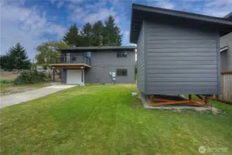 Spacious yard with modern home—perfect for outdoor living and play.