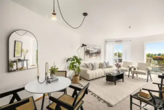 The living and dining areas are wrapped in natural light, seamlessly connecting to the balcony