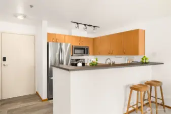 Modern breakfast bar offers casual seating and flows easily to dining area.
