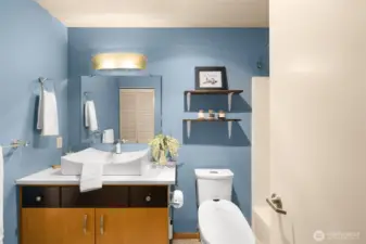 The modern bathroom features sleek fixtures & oversized sink.