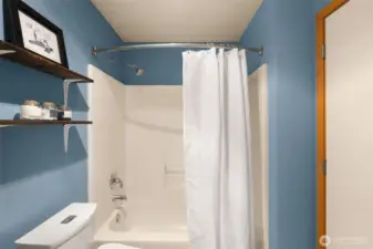 Full bath with stylish ceramic tile "hardwood"