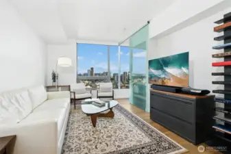 Sunlit living area with modern finishes and city views