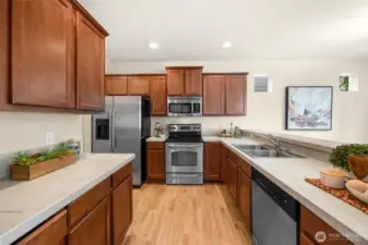 Gourmet kitchen with an abundance of counter space and oak shaker-style cabinets.  Stainless Steel appliances and double steel sink.  Solid Oak hardwood floors for a very classy look.